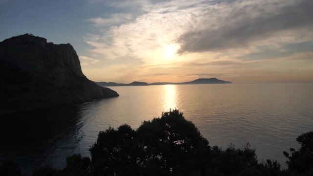 Sunrise morning view of the ocean with mountains in the background. New world view of the sea and mountains from Cape Kapchik - Powered by Adobe