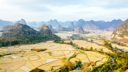 aerial view of karst mountains surrounding rural farmland at Mingshi Village (Mingshi Tianyuan) in Daxin County, Chongzuo city, Guangxi Province, China