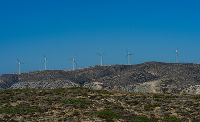 Wind turbines in the mountains. Kinetic energy. Wind generators.