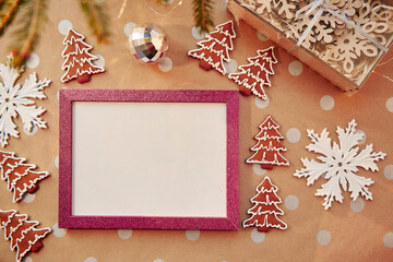 Christmas homemade gingerbread cookies with pink mock up frame. Homemade baked cookies. Festive aesthetic card. Christmas atmosphere. Merry Christmas and home coziness concept. High quality photo