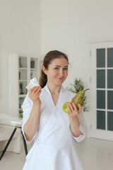 Medicine, healthcare and people concept - Friendly family doctor at hospital. Close up Woman therapist in white uniform with stethoscope on light background