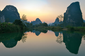 Beautiful rural landscape surrounded by Karst mountains during sunset in winter at Mingshi Village (Mingshi Tianyuan) in Daxin County, Chongzuo city, Guangxi Province, China