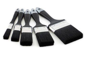 Five paint brushes on white