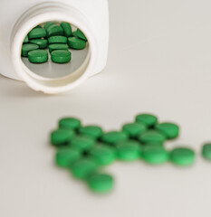 Medication Concept: Glass Container and Scattered Tablets