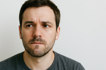 Fototapeta premium Thoughtful caucasian man with pensive expression on face reflecting deep thoughts and introspection concept of contemplation, human emotion, personal reflection