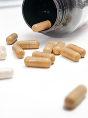Dietary Supplements: Capsules Scattered from Container