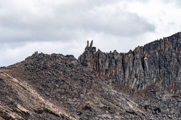 A rocky peak on the Qinghai-Tibet Plateau, its summit crowned with a pair of rock formations resembling rabbit ears