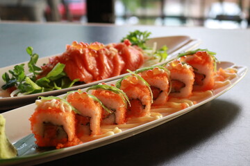 Sushi and Sashimi beautifully arranged on a plate, showcasing a variety of fresh ingredients and flavors