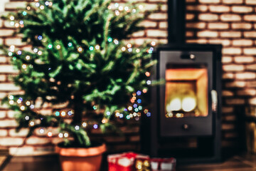 blurred background of decorated Christmas tree and fireplace