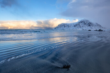 Evening Beach and Snow-Capped Mountains