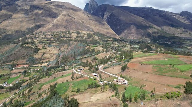 Huaraz, Peru: Drone footage of the road heading to Laguna Paron in Huaraz, Peru. Taken with tilt up motion featuring dramatic valley under cloudy sky