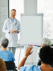 Portrait of a young doctor teaching on a seminar in a board room or during an educational class at...