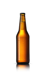 brown glass bottle with drops of beer