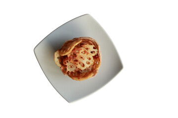 A delicious open-faced sandwich topped with cheese and other ingredients, served on a square white plate