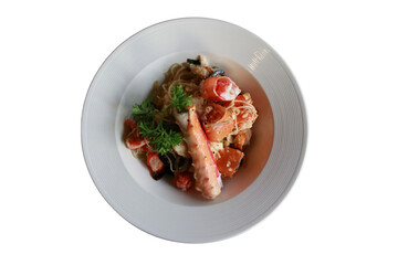 A Delicious plate of crab pasta with fresh ingredients in a round white plate 