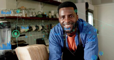 Leaning barista wearing apron behind countertop in cafe, with data graphics and coffee machine