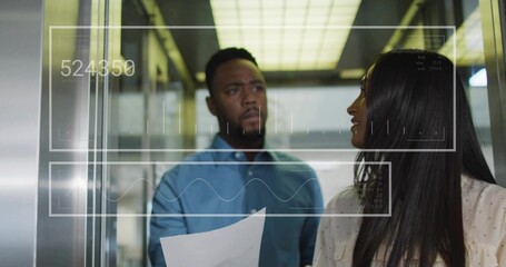 Analyzing two coworkers in tops examining digital overlays in office elevator with printed document