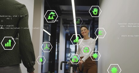 Mid adult woman pushing bicycle in office hallway, with floating sustainability icons and code text