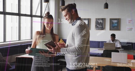 Teen female and adult male reviewing documents and tablet in office lounge, with code overlay