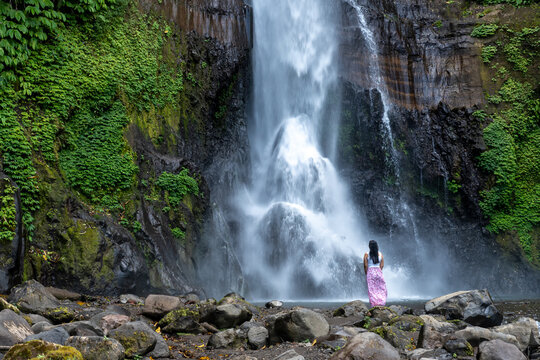 Woman at Gitgit waterfall in Singaraja, Bali, Indonesia