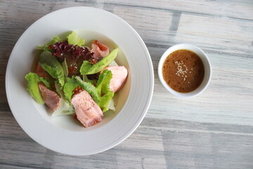 A Fresh and Flavorful Salmon Salad in a white plate