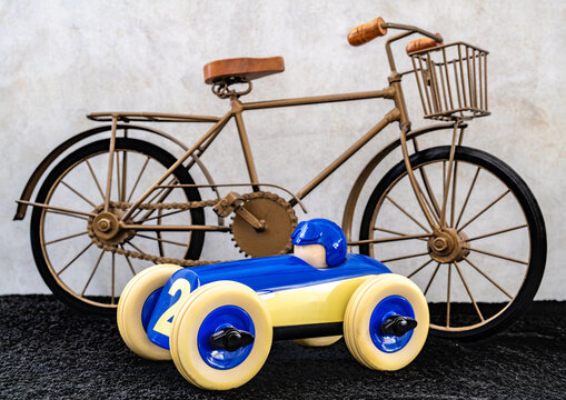 miniature old-fashioned bicycle and car - Powered by Adobe