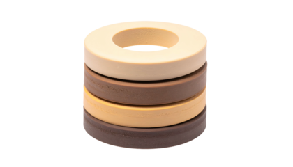 Stack of four differently colored donut-shaped items with a hole in the center