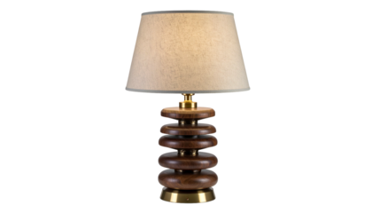 A stylish table lamp with a stacked wooden base and beige lampshade, isolated on black
