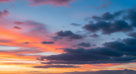 Fototapeta premium Stunning vibrant sunset paints the sky with fiery oranges pinks and dramatic dark clouds creating a breathtaking natural spectacle
