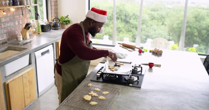 Piping dough onto griddle at kitchen island African American man flipping pieces after seeing edges