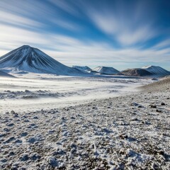 Snowcovered volcano landscape with a blue sky and wispy clouds