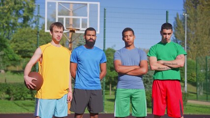 Portrait of sporty fit diverse multiracial male basketball players with ball standing on outdoor court, looking with serious stares, expressing confidence, readiness for game and determination - Powered by Adobe
