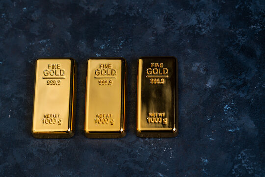 Shiny gold bar placed on a table, Finance and investment concept image, gold rate background