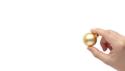 Hand holding a small golden christmas ornament ball between fingers, isolated on transparent and white background