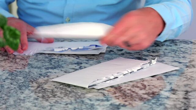 Middle Aged Man is Depressed and Stressed Over Large Pile of Bills - American Debt