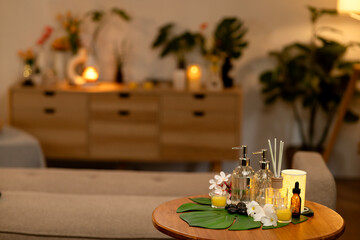 Home spa relaxation setting with essential oils and candles creating tranquil peaceful ambiance perfect for self care and wellness cozy living room interior design comfort