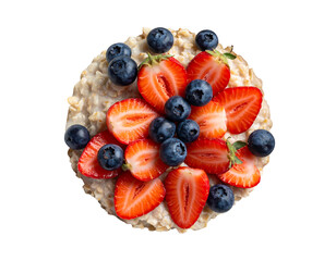 Overhead view of healthy oatmeal with fresh strawberries and blueberries isolated on transparent background