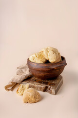 Homemade butter cookies in a clay plate on a beige background, copy space.