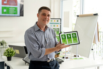 Caucasian man presenting ESG environmental social governance concepts digital tablet modern office...