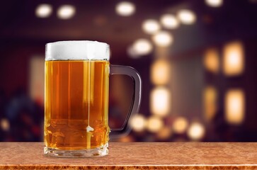 Cold mug of tasty fresh beer in a bar