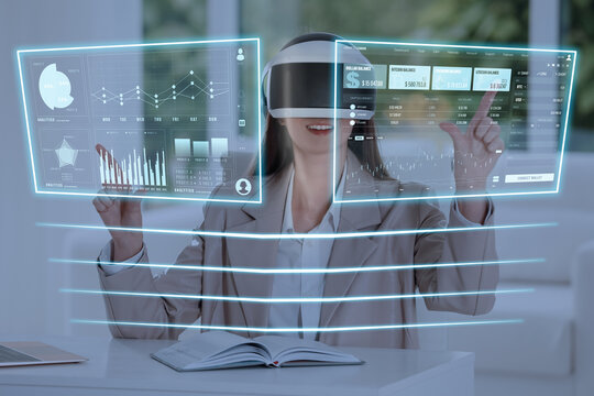 Woman using digital screen with data via virtual reality headset in office. Innovative technology for business