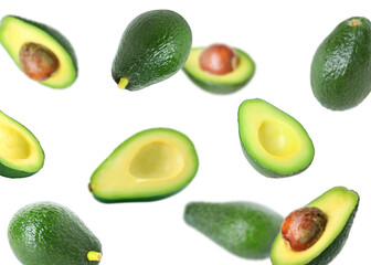 Fresh avocado falling on white background. Whole and sliced