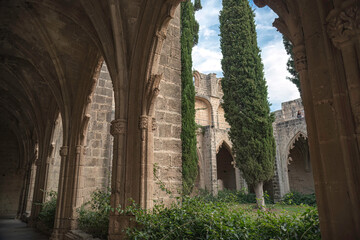 Cloister showing architectural detail with stone pillars and arches in Bellapais Abbey. Kyrenia District, Cyprus