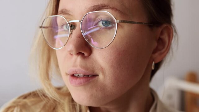 Girl in glasses hiccuping, close-up shot showing natural reaction.