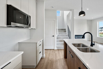 Kitchen with a white counter and a black sink
