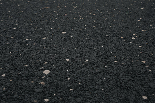 Black rubber flooring surface texture background with white specks for gym playground safety surface