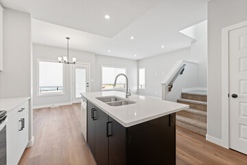 Kitchen with a white island and a sink