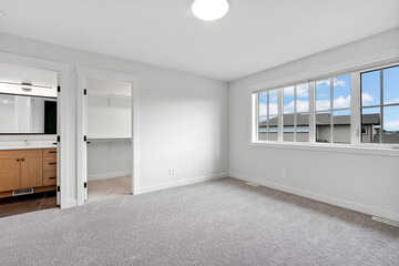 Large, empty room with a window and a bathroom