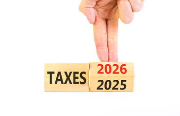2026 taxes new year symbol. Concept words 2026 taxes on beautiful wooden blocks. Beautiful white paper background. Businessman's hand. Business and 2026 taxes new year concept. Copy space.