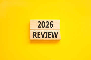 2026 Review symbol. Concept words 2026 Review on beautiful wooden blocks. Beautiful yellow paper background. Business and 2026 review concept. Copy space.